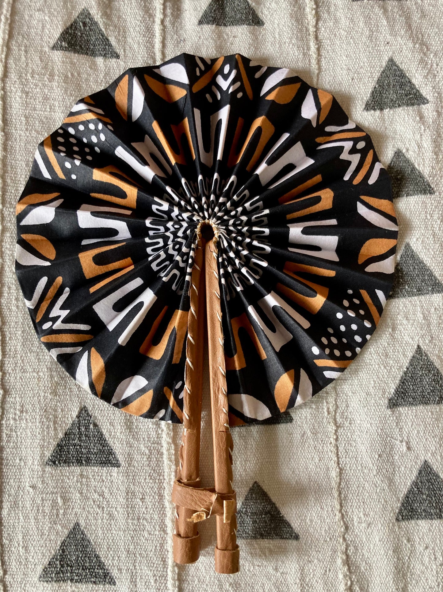 Fan- Collapses for easy storage, made from African wax fabric