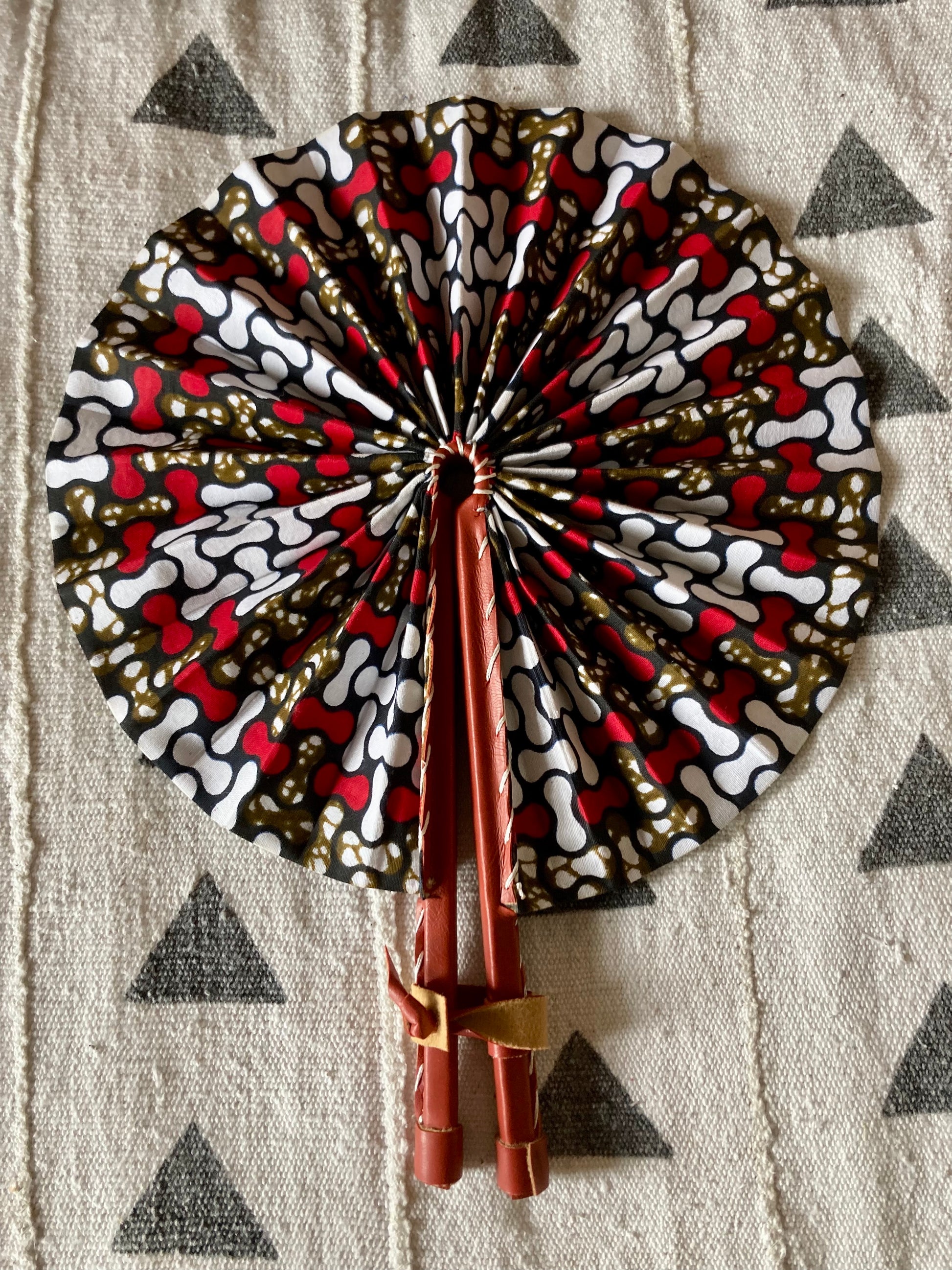 Fan- Collapses for easy storage, made from African wax fabric