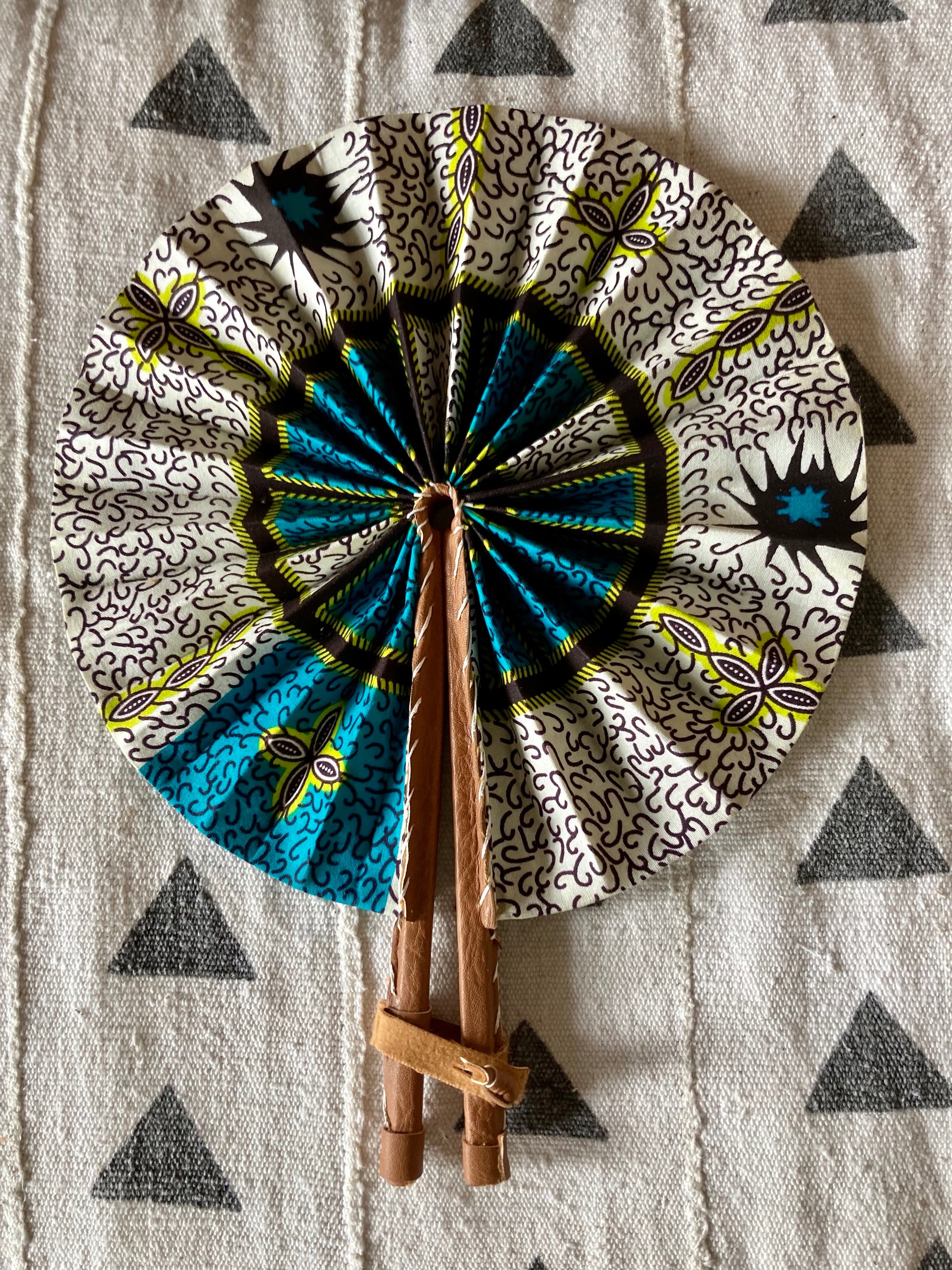 Fan- Collapses for easy storage, made from African wax fabric